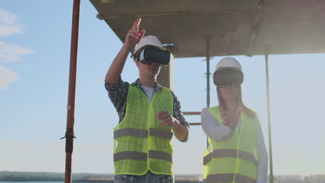 Waist-up-portrait-of-two-modern-construction-workers-using-VR-gear-to-visualize-projects-on-site-copy-space